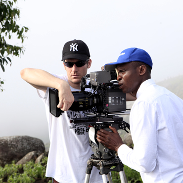 Cinematographer Yinka Edward with Danono Media crew member on the set of The Milkmaid in Mambilla Plateau, Taraba State, Nigeria